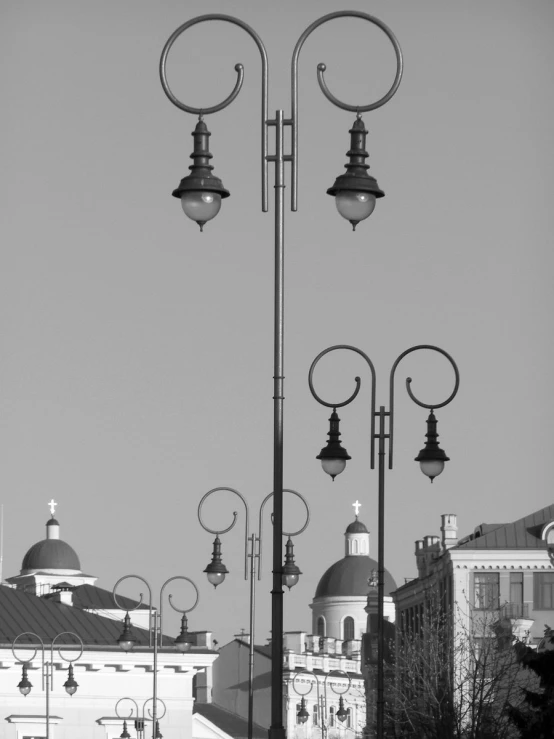 the lights on a pole shine brightly against a clear sky