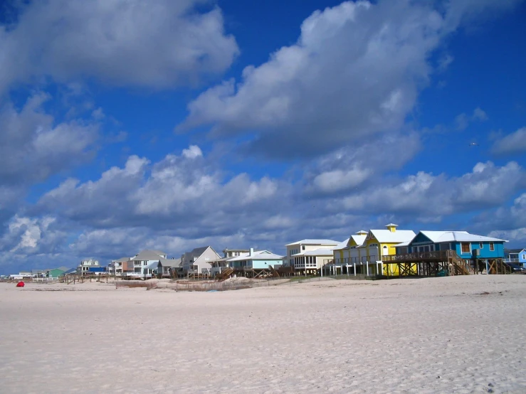 the beach houses are colorful on this cloudy day