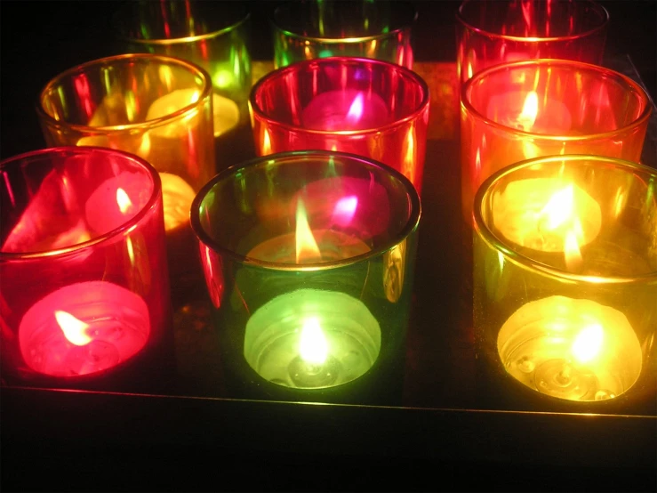 colorful candles lit up in an array of different sizes