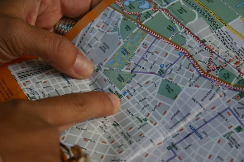 person pointing to map in large city area