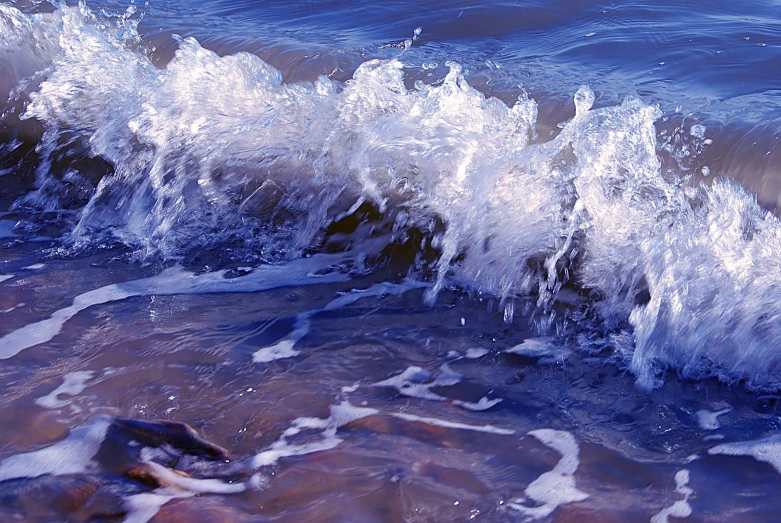 an ocean with large splash on rocks and water