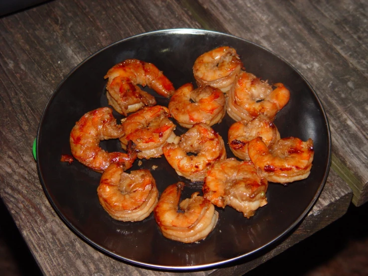 this is a pan of fried shrimp on a wooden table