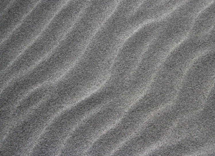 an image of the surface of sand made by water