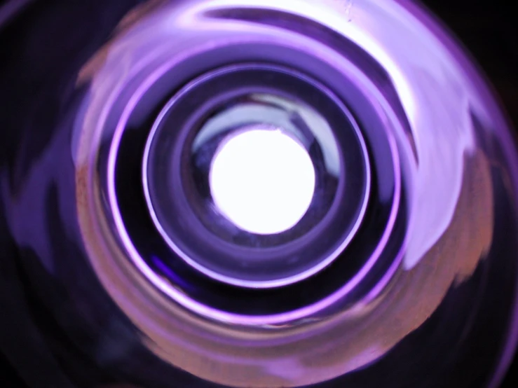 an abstract image of purple lights in a round