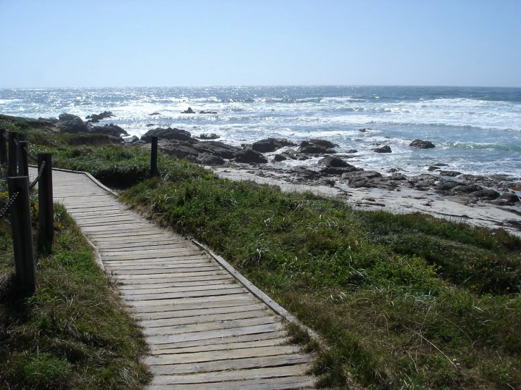 an image of a pathway next to the ocean