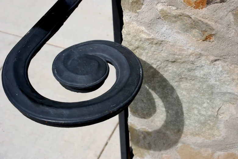 the railing around the bench is made of wrought iron