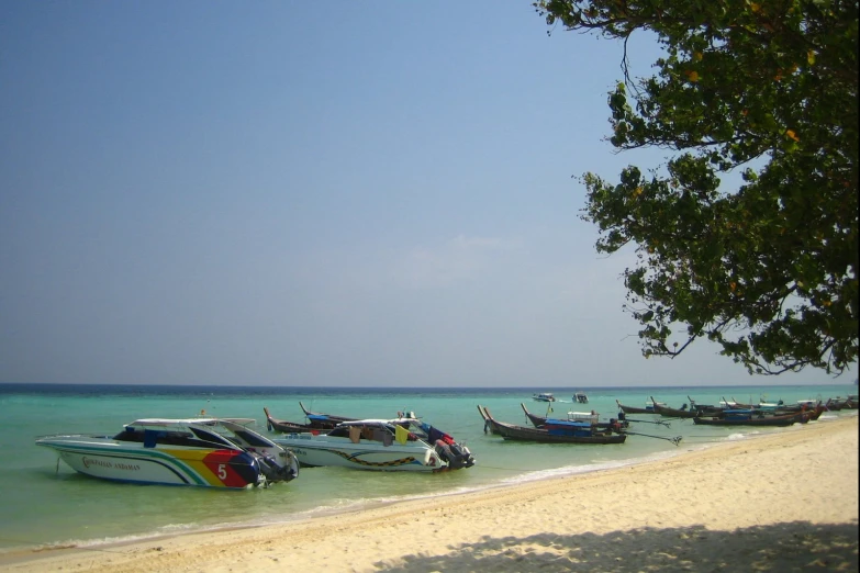 a group of boats sitting on top of a beach