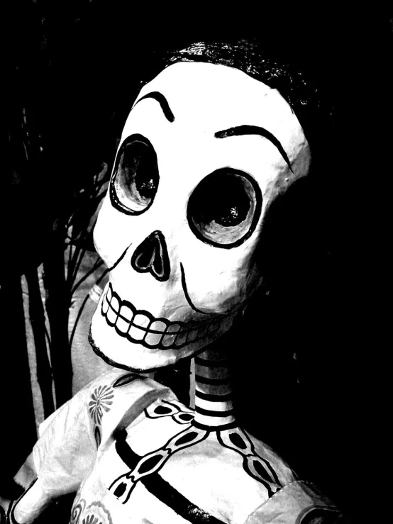 a skeleton statue sitting in a black and white po