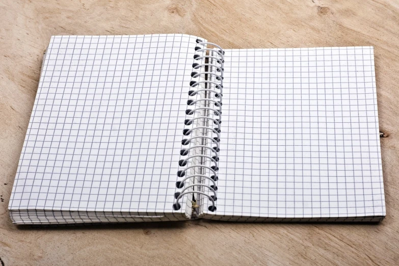 a spiral notebook filled with black and white squares