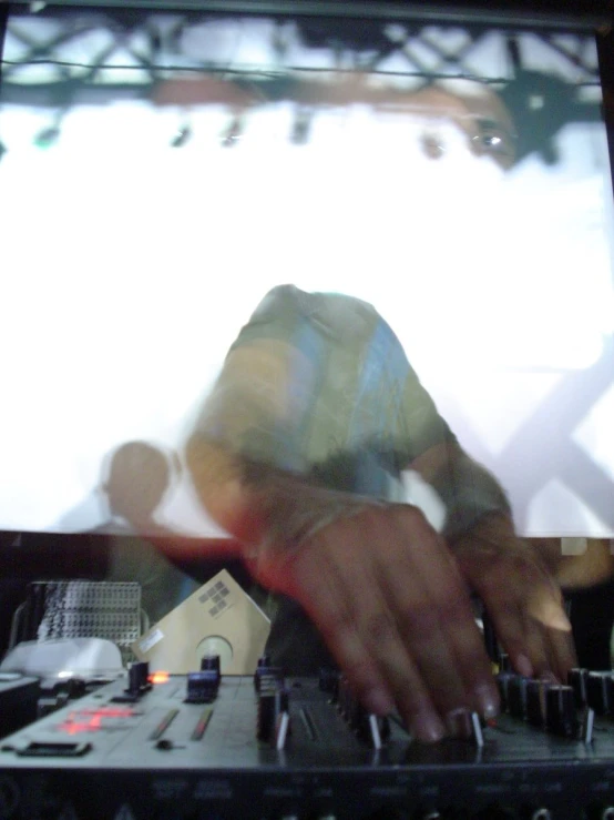 dj on large video screen playing at a party