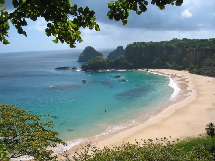 a sandy beach that is next to the water