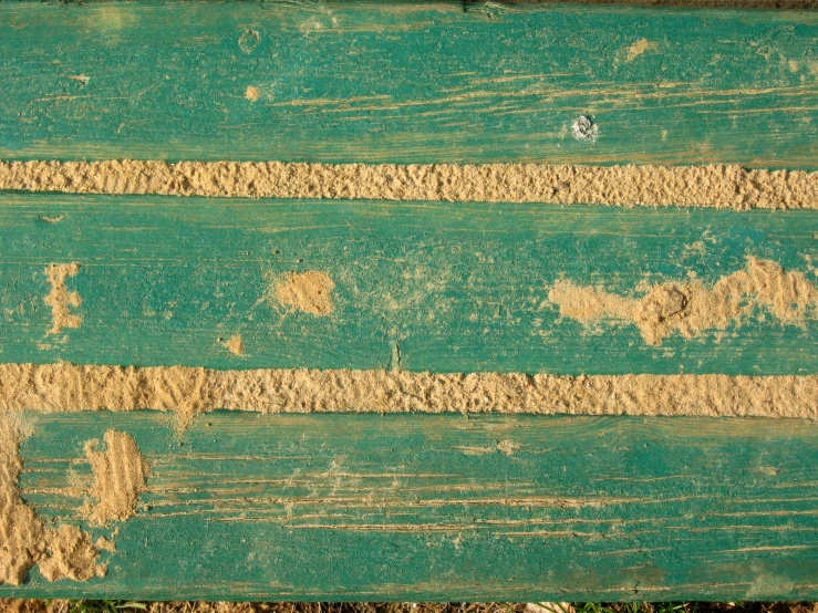 an old weathered plank is peeling and chipping paint