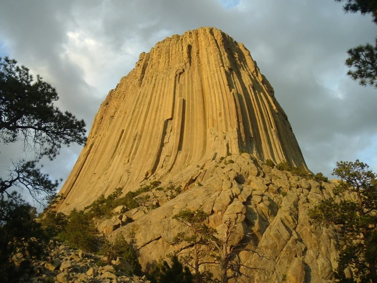 the tall, very large rock is standing alone