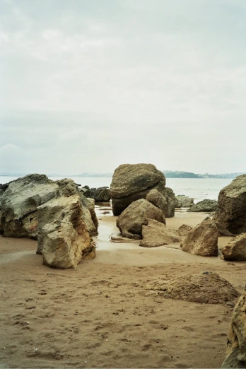 large rocks are lying out on the beach