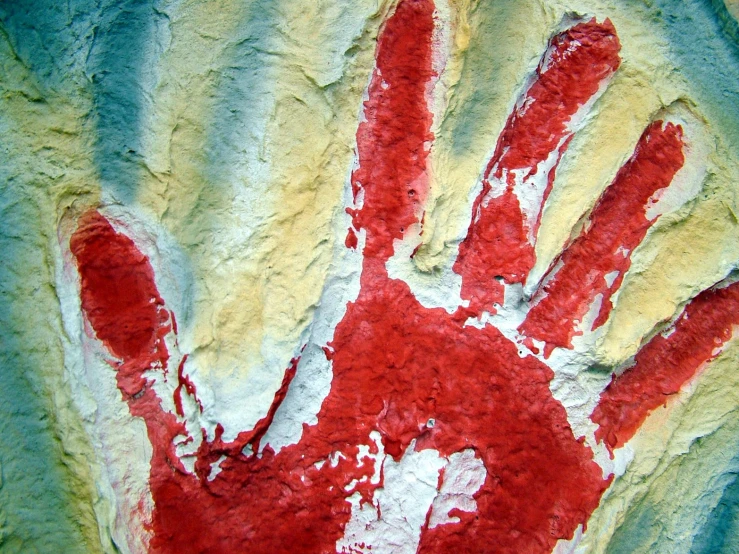 an image of a red handprint on the rock