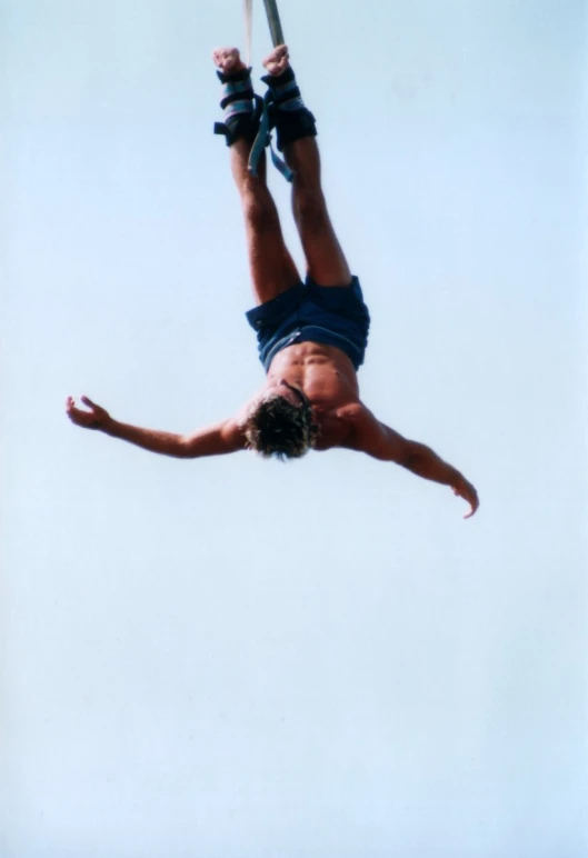 a person upside down on the ground while in the air