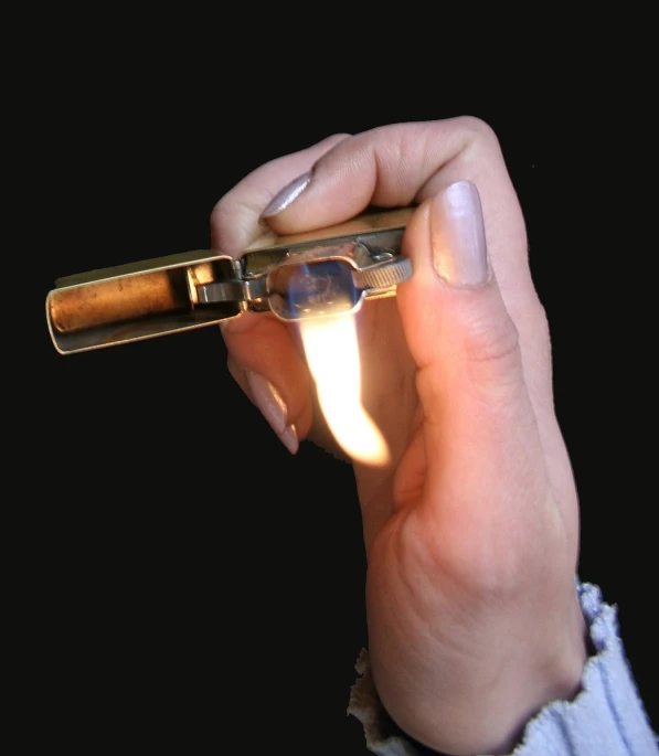 a woman holding a lit lighter in her right hand