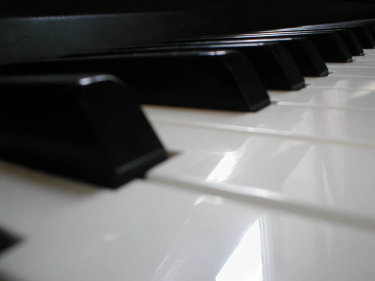 a close up of an electronic piano and a white and black piano