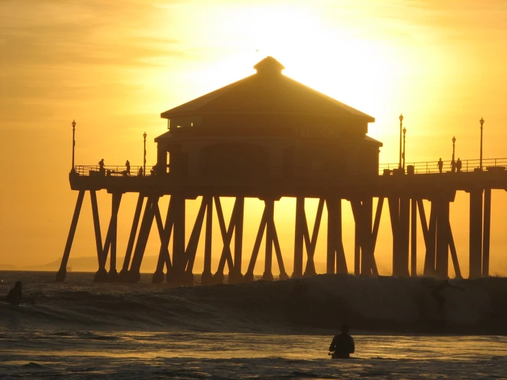 a picture of people in the water and a large pier