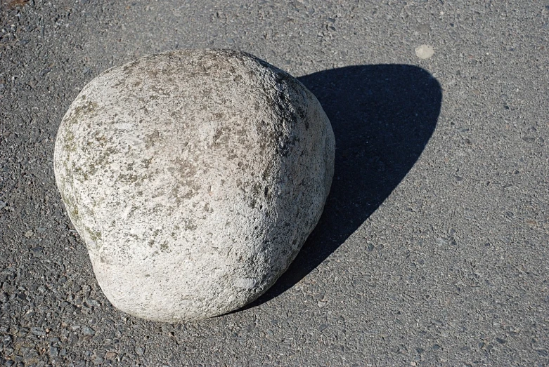 two rocks shaped like faces sitting on top of the ground