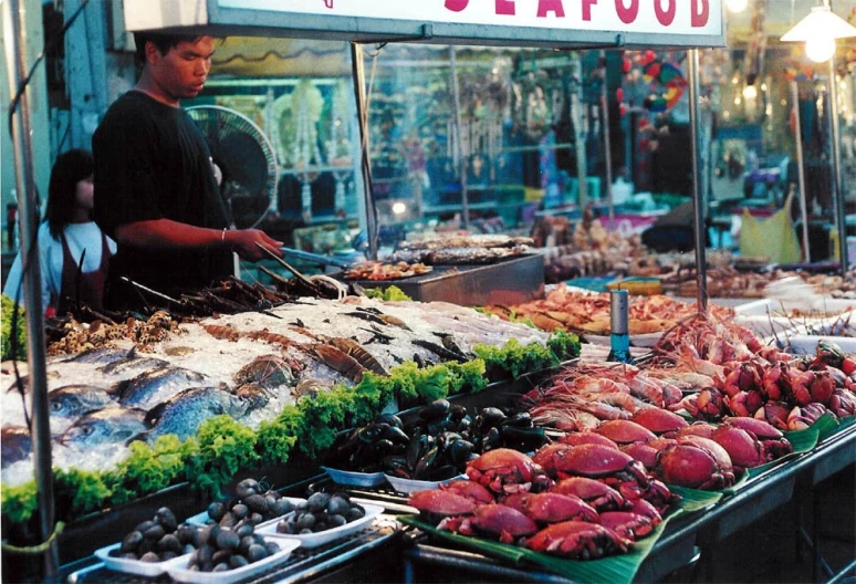 seafood for sale in front of a seafood stand