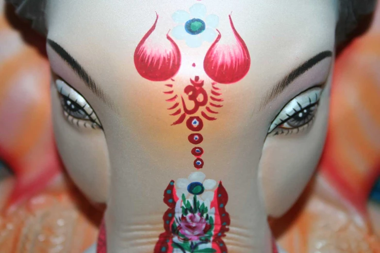 a close up view of a woman's face with artistic design