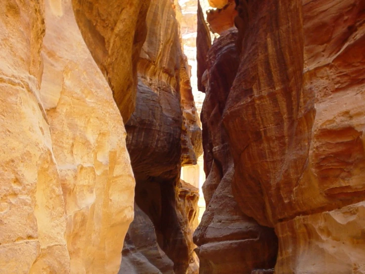 two hikers climbing up the side of a canyon