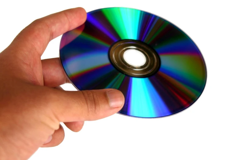 a person holding a shiny cd in front of the camera