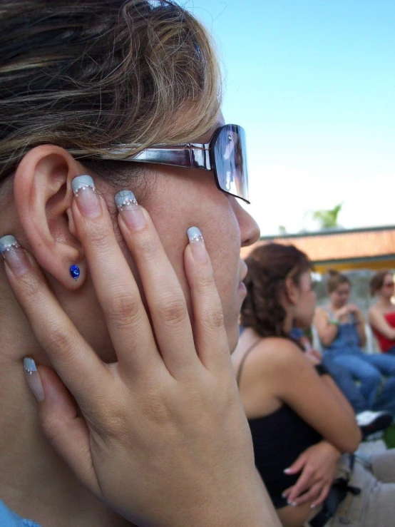 a woman with her head down wearing a pair of glasses