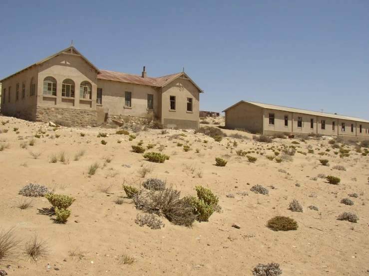 a very large stone house sitting on a desert