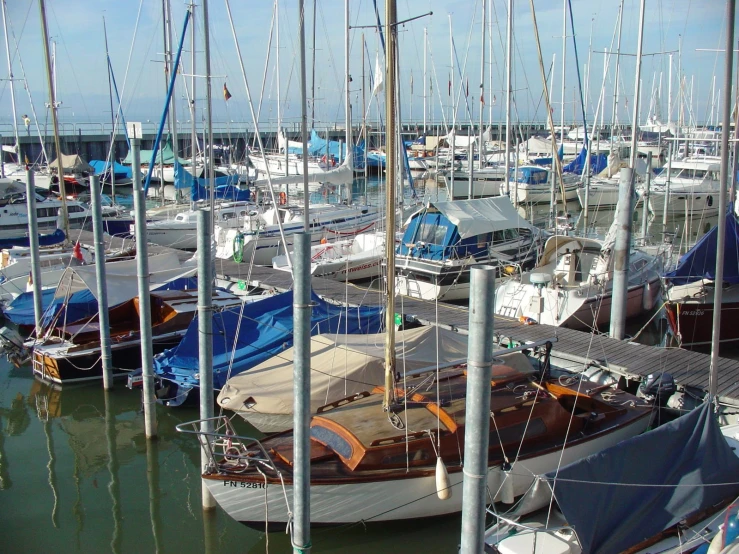 a boat dock filled with boats on a bright day