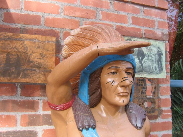 a statue is shown on a brick wall