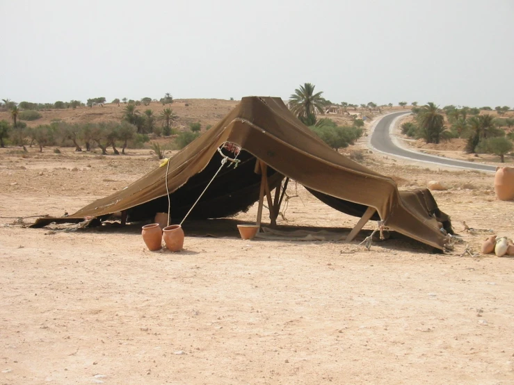 the desert has no grass or shrubs and a tent set up on it