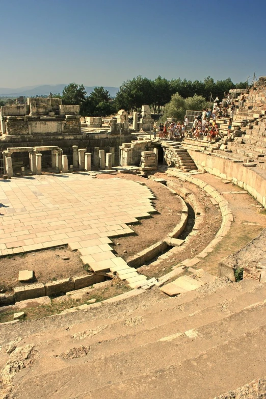 ancient city in middle of a ruined world with people milling about