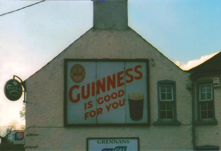 a sign on the side of a building reads guinness is good for you