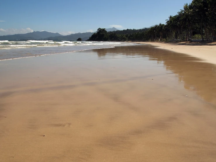 sandy beach with mountains in the distance