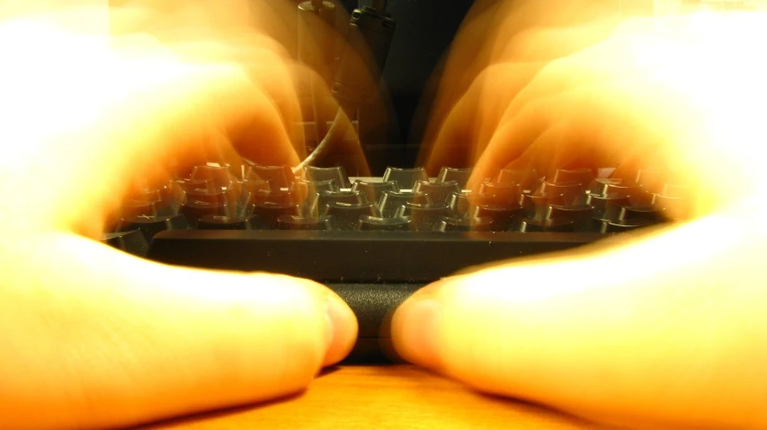 a person typing on a keyboard with their hands