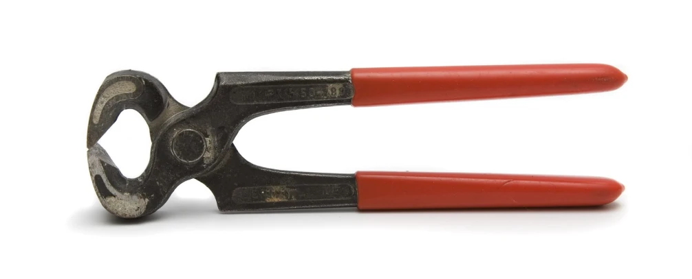 a pair of scissors are in use on a white surface