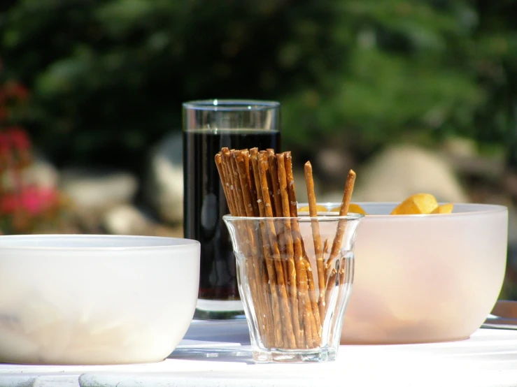 two cups and two bowls sit on the table with ers in them