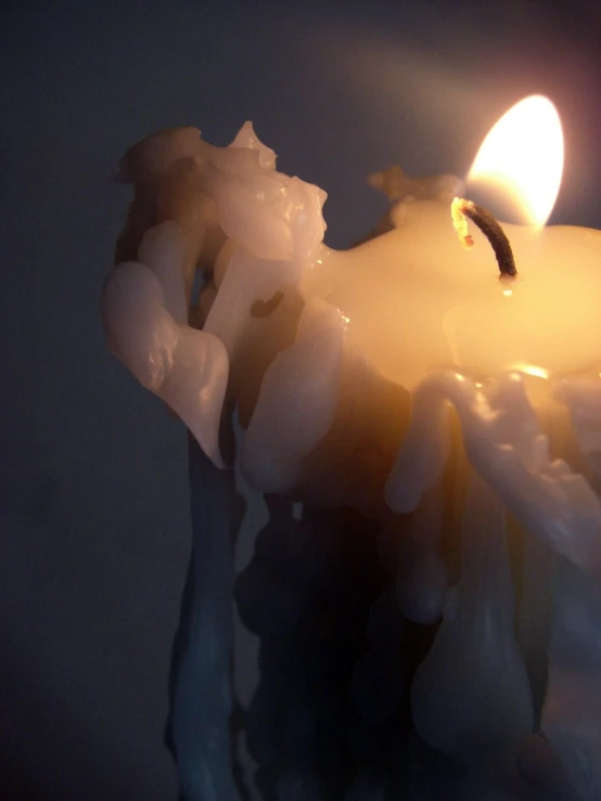 a lit candle that is sitting on some water