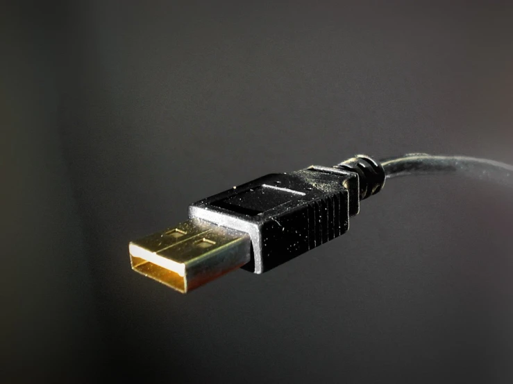 a small white object connected to a long black cord