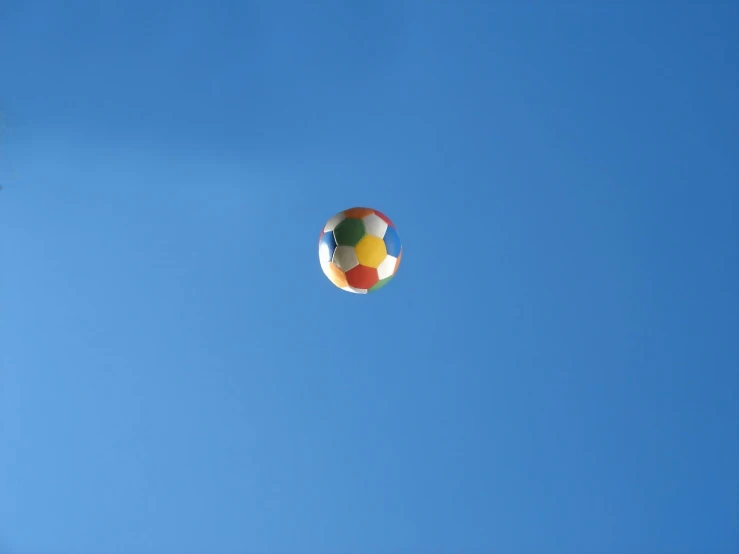 a single large colorful ball flying up in the sky