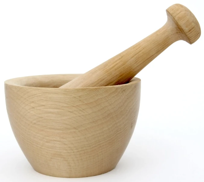 a wooden mortar and pestle in a wooden bowl