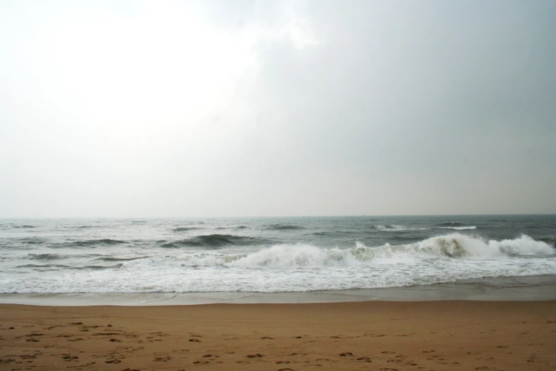 the ocean is still moving and gray in color