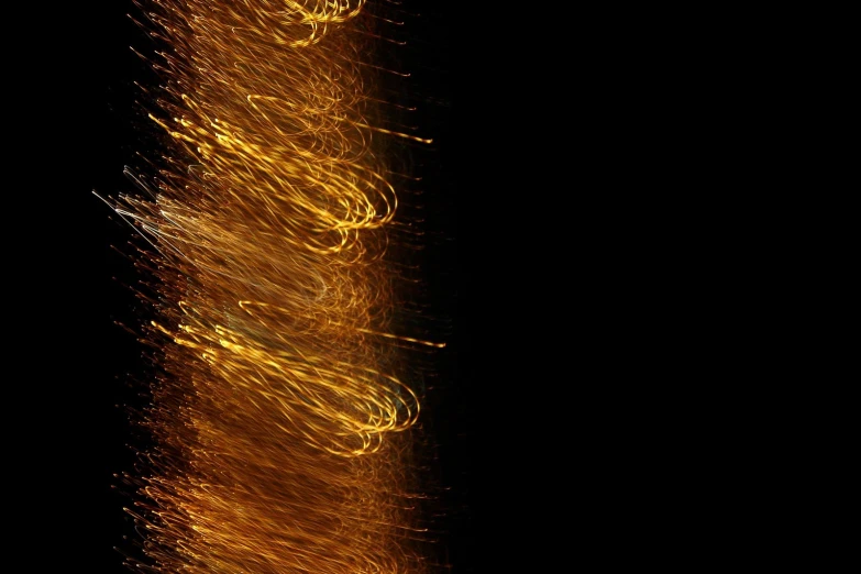 bright golden fireworks are glowing brightly against a black background