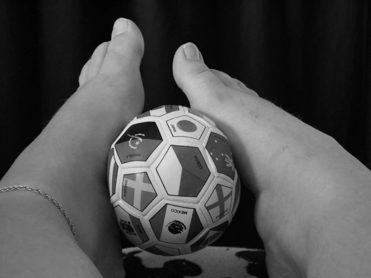 two people holding a large soccer ball in their hands