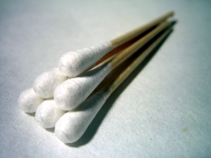 the cotton balls are lined up on a table