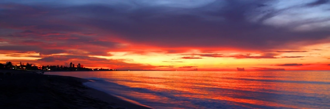 a sunset on the ocean with the sun setting