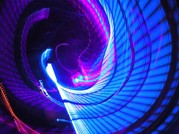 a spiral light at night shows purple and blue