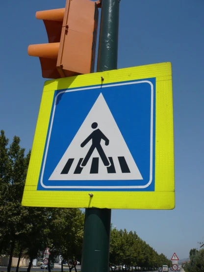 a road sign in a crosswalk for pedestrians crossing the street